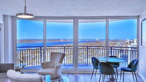Enjoy expansive views of the coastal cityscape from the balcony, featuring a round table and four chairs.