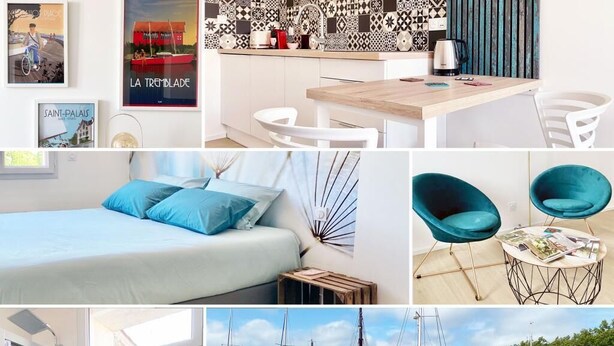A modern hotel room with a bed, a desk, and a view of a marina. - Your modern retreat in the heart of Rochefort - A unique experience (Rochefort)