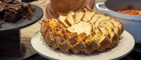 A loaf of bread on a plate with a rustic background.