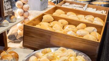 A display of various baked goods including bread rolls and pastries.