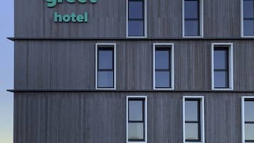 A modern building with a sign reading 'greet hotel.'
