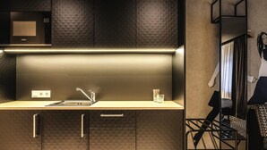A modern kitchen with a microwave, sink, and cabinet drawers. - ibis Styles Arnhem Centre (Arnhem)