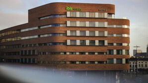 A modern hotel building with a curved facade, multiple windows, and a sign indicating it is part of the ibis Styles hotel chain. - ibis Styles Arnhem Centre (Arnhem)