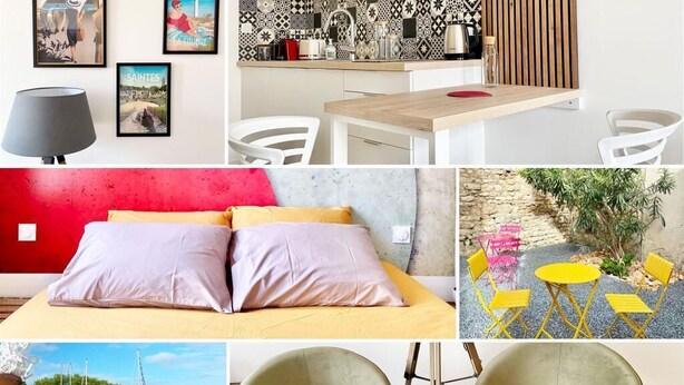 Una cocina moderna con encimera de madera y armarios blancos, un comedor con mesa y sillas de madera, un dormitorio con pared roja y cama con dos almohadas, y una sala de estar con pared de piedra y mesa amarilla.