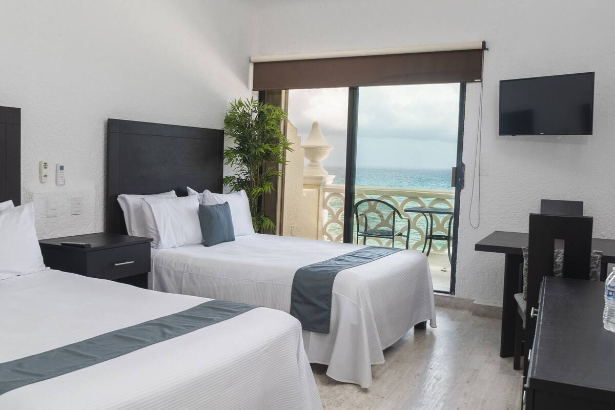 Apartamento luxo, vista para a praia | Cofres nos quartos, escrivaninha, Wi-Fi de cortesia, roupa de cama