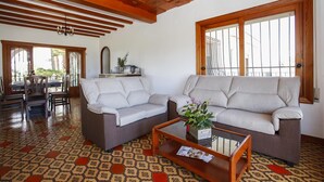 A living room with two sofas, a coffee table, and a patterned floor. - 030 Villa Marines (Denia)