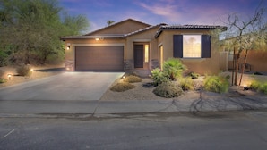 A single-story house with a garage, a front porch, and a landscaped garden. - Luxury Golf Retreat w/ Saltwater Pool, Spa &  View, Walk2-Coachella, Stagecoach (Indio)