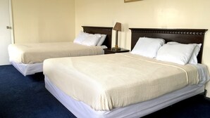Two single beds with white linens, a dark headboard, a bedside lamp, and a framed picture on the wall. - Half Block from Belmar Beach!! (Belmar)