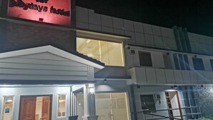 A hotel entrance with a sign reading "Bohydays Hotel" and a visible staircase leading to the entrance. - Reddoorz @ Jollydays Hotel Nueva Ecija (San Jose City)