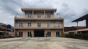A multi-story building with balconies and air conditioning units. - OYO 3816 The Tispa Syariah Residence (Palembang)
