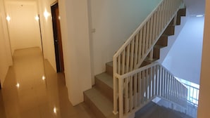 A staircase with white railings leading to an upper floor. - OYO 3816 The Tispa Syariah Residence (Palembang)