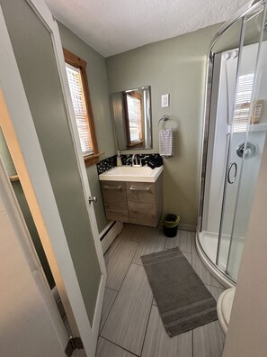 Shower, hair dryer, towels, shampoo