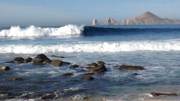 A rocky shoreline with waves crashing onto the rocks.