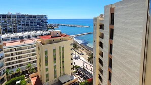 A coastal hotel with multiple floors, balconies, and a view of the sea. - Magnificent 10th-Floor Studio with Sea Views (Marbella)