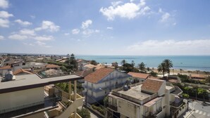 A coastal town with buildings, a beach, and the sea.