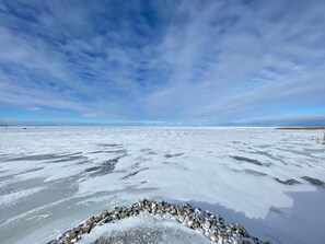 A frozen landscape with a clear sky. - Cozy Quiet Island Light House on Water Front (Fairgrove)