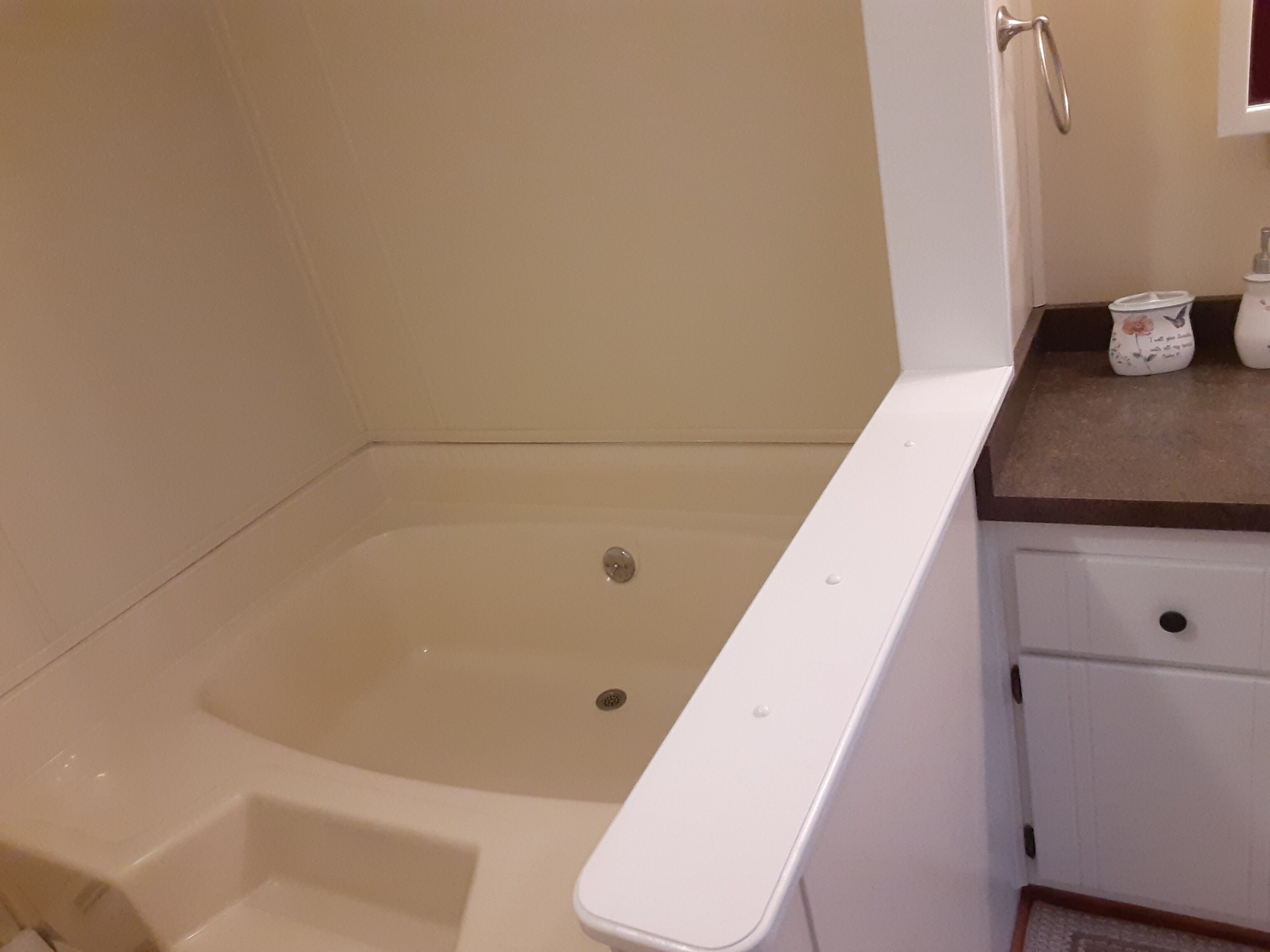 A bathroom with a bathtub, a toilet, and a sink.