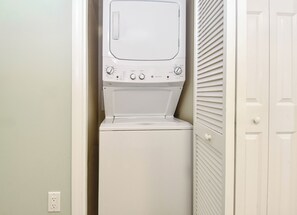 A compact, white, wall-mounted washer and dryer unit with control knobs and a small display screen. - Relaxing Updated Condo w/ Stunning Resort Pool at The Palms of Destin! ππ΄π (Destin)