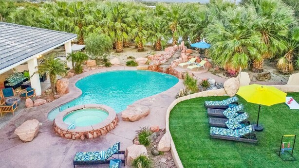 A backyard with a swimming pool, hot tub, and outdoor seating area with umbrellas. - Pickle+Basketball|Billiards|9bdr+6bath|Saltwater (Desert Hot Springs)