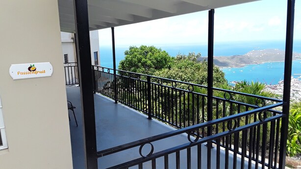 A balcony with a view of the sea and mountains. - PASSION FRUIT Apartment for work or getaway (St. Thomas)