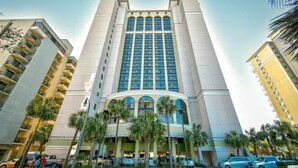 A tall hotel with a central atrium, multiple floors, and a modern architectural design. - Oceanfront 3BR/2BA,walking distance to everything. (Myrtle Beach)
