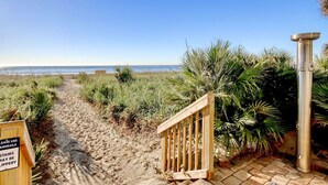 A sandy beach path leading to a wooden gate with a sign warning against using stairs. - Oceanfront 3BR/2BA,walking distance to everything. (Myrtle Beach)