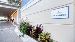 A hotel entrance with a sign reading "The Breakers Resort Paradise." - Oceanfront 3BR/2BA,walking distance to everything. (Myrtle Beach)