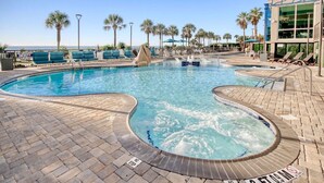 A pool area with lounge chairs, a hot tub, and a view of the ocean. - Oceanfront 3BR/2BA,walking distance to everything. (Myrtle Beach)