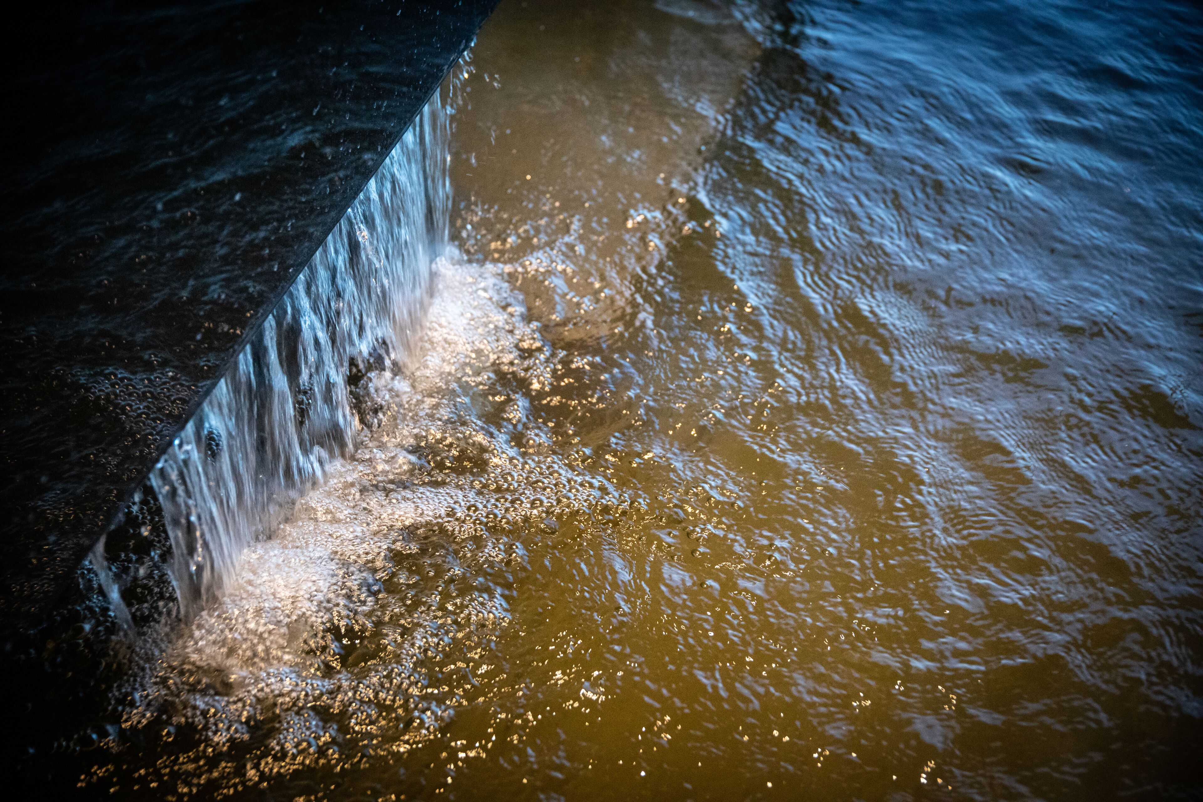 A close-up of water flowing over a rocky surface.