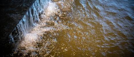 A close-up of water flowing over a rocky surface.
