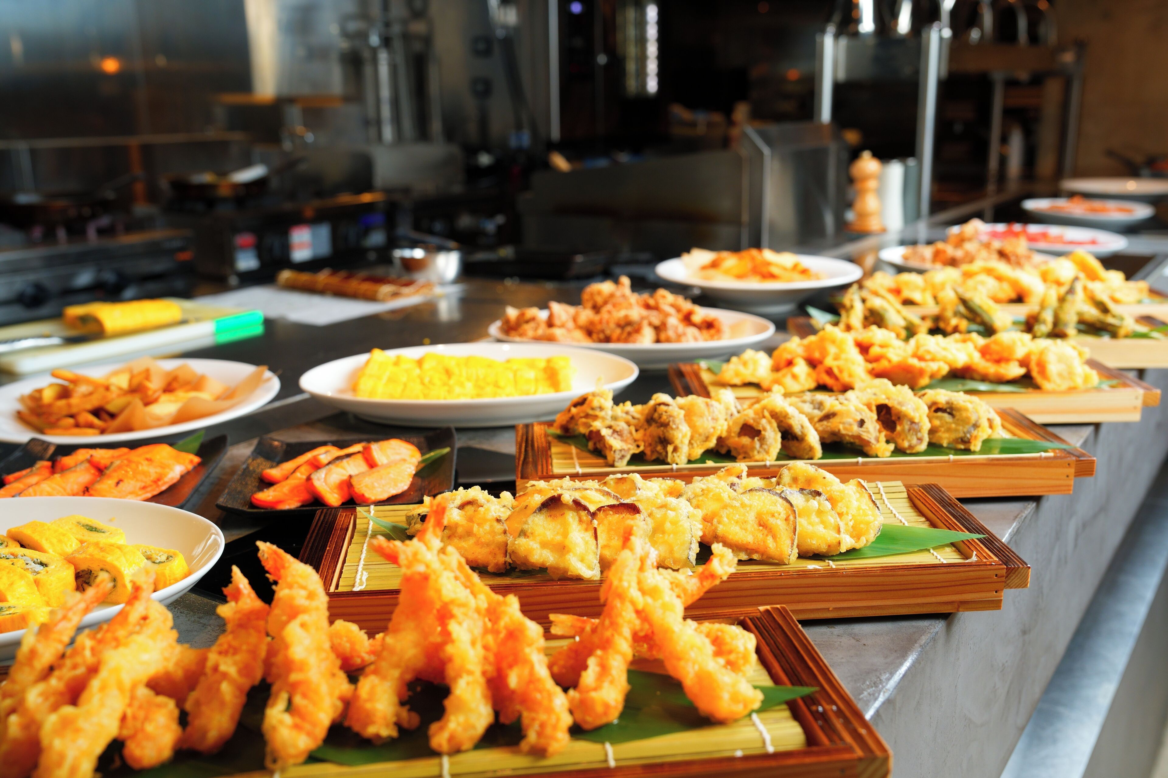 A buffet with various fried foods and dishes.