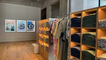 An art gallery with wooden floors and walls adorned with framed artworks.