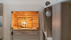 A wooden-framed wall with a spherical light fixture.