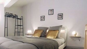 A modern bedroom with a bed, two nightstands, a ladder, and three framed pictures on the wall. - ★ Bright ★ Quiet ★ City centre ★ Easy Parking ★ WIFI ★ (Le Puy en Velay)