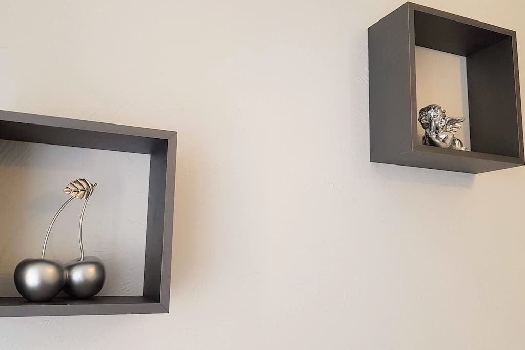 Two wall-mounted shelves with minimalist decor.