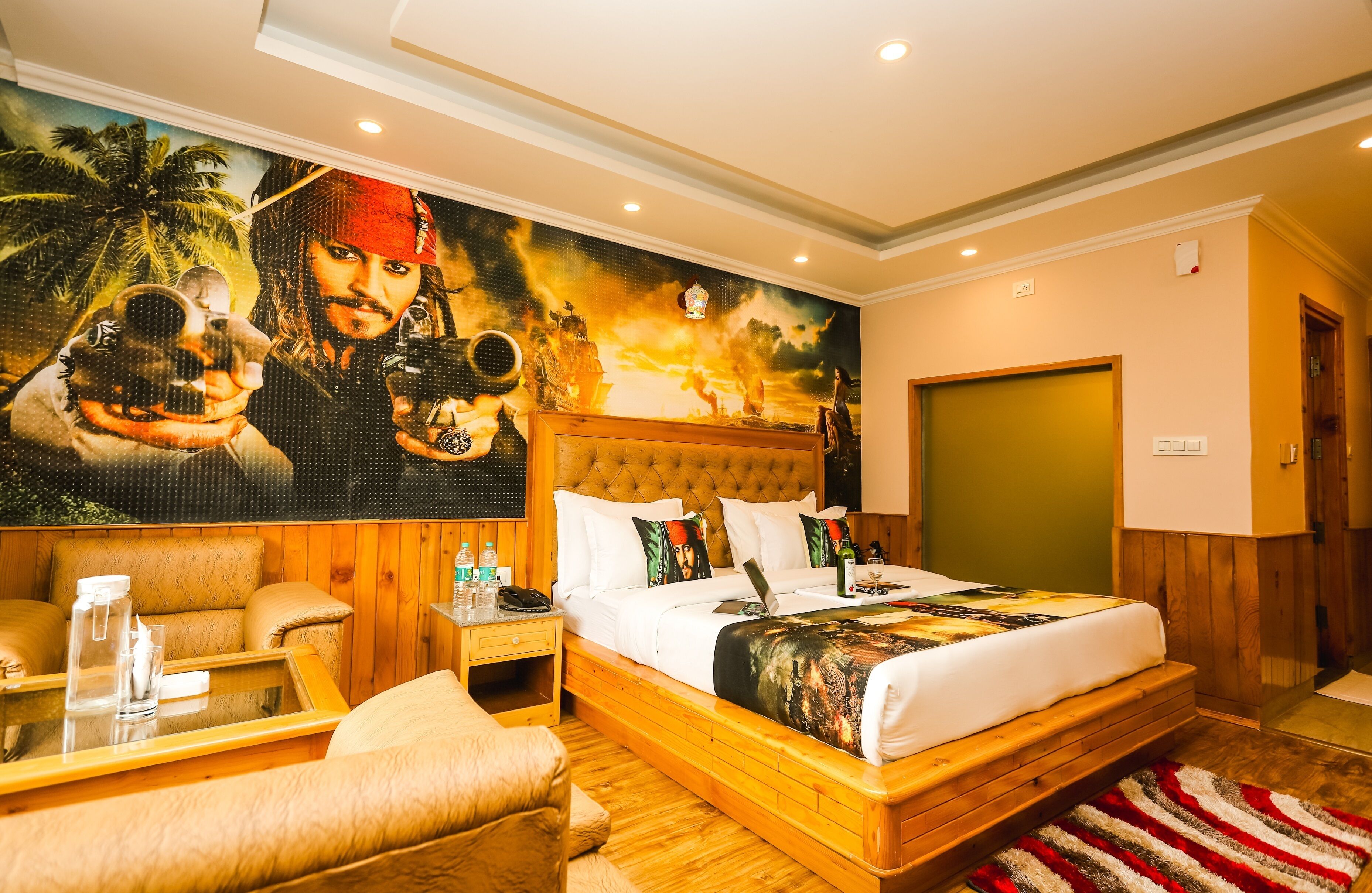 A spacious bedroom with a large bed, wooden headboard, and a mural of a pirate on the wall.