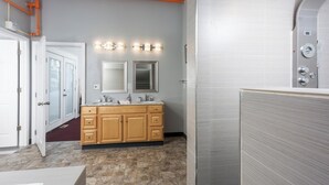 A bathroom with a vanity, double mirrors, and a shower enclosure. - Sleeping Lady Mountain View( The WOW Factor) Suite (Anchorage)