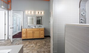 A bathroom with a vanity, double mirrors, and a shower enclosure. - Sleeping Lady Mountain View( The WOW Factor) Suite (Anchorage)
