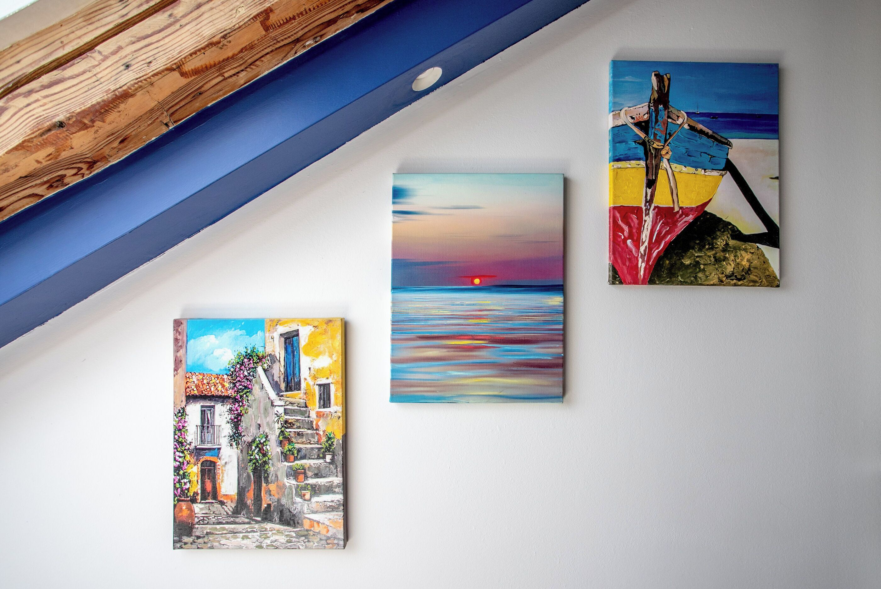Three paintings on a wall.