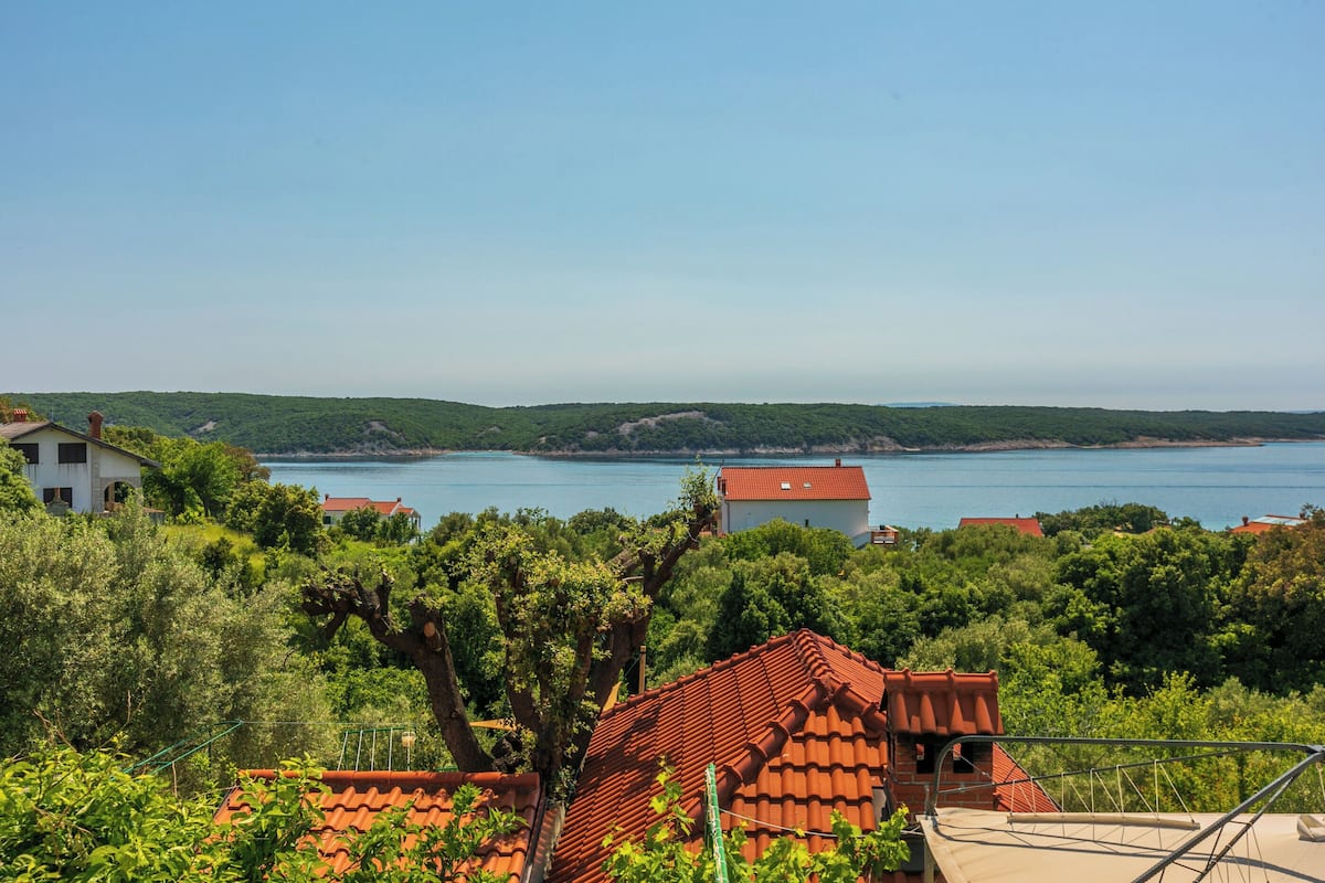 A coastal view with houses and a clear sky.