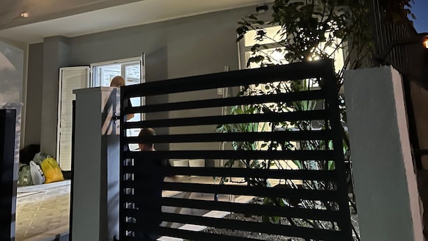 A modern building with a gated entrance, a balcony, and outdoor lighting. - Apartments Milica (Kastel Stari)