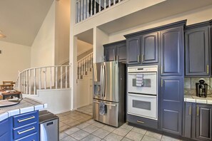 Enjoy cooking in this well-equipped kitchen with a spacious layout, island, and ample counter space.