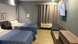 A hotel room with two beds, a desk, a chair, a TV, and a window with curtains. - Hotel Le-Gar (Monterrey)