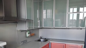 A modern kitchen with stainless steel appliances, a built-in oven, and a sink.