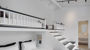 A modern bedroom with a bunk bed, a staircase, and a bathroom with a sink and mirror. - Athenian Black Villa (Saronikos)