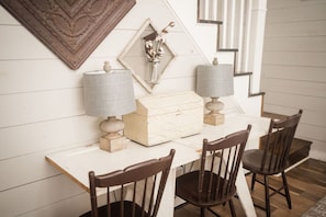 Enjoy meals in a stylish dining area with a wooden table, chairs, and decorative accents.