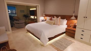 A bedroom with a bed, bedside table, lamp, and wardrobe.