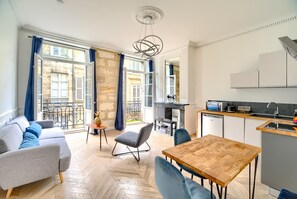 A modern apartment with a living area, dining space, and kitchen.
