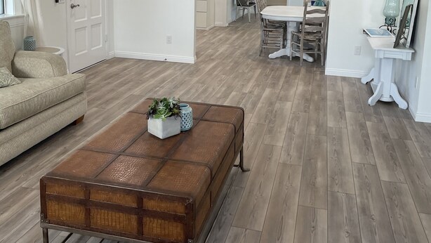 A spacious living room with a wooden coffee table, a ceiling fan, and a dining area with a white table and chairs. - The Bluebird House Near Wineries Historic Downtown Murrieta  (Murrieta)