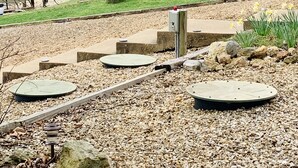 A park with a picnic area, a covered boat storage, and a large tree with pink blossoms. - Private COVE! Bring or rent boat for delivery. Boat Ramp/Dock/Kayak/SUPs/Fishing (Camdenton)